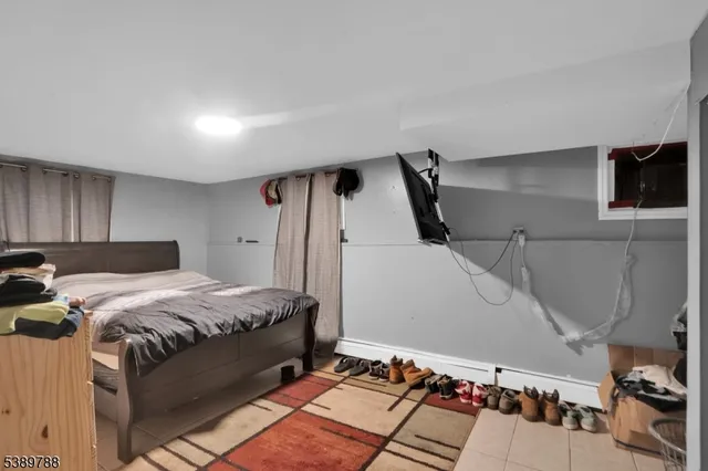 a bed room with a bed and a television