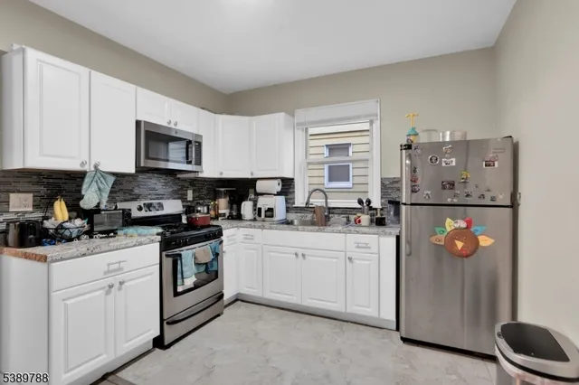 a kitchen with stainless steel appliances granite countertop a stove and a sink