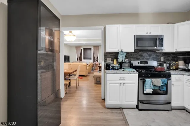 a kitchen with stainless steel appliances a stove microwave and cabinets