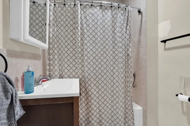 a bathroom with a sink and a shower curtain
