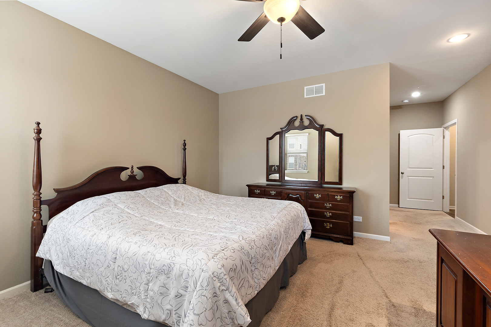 2073 Rownham Hill Road New Lenox, IL 60451 - Photo 14 of 34 a bedroom with a bed and a chandelier
