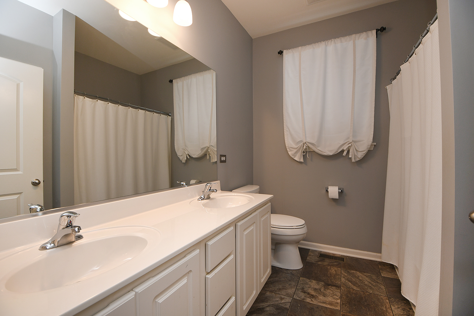 2073 Rownham Hill Road New Lenox, IL 60451 - Photo 20 of 34 a bathroom with a sink a toilet and a mirror