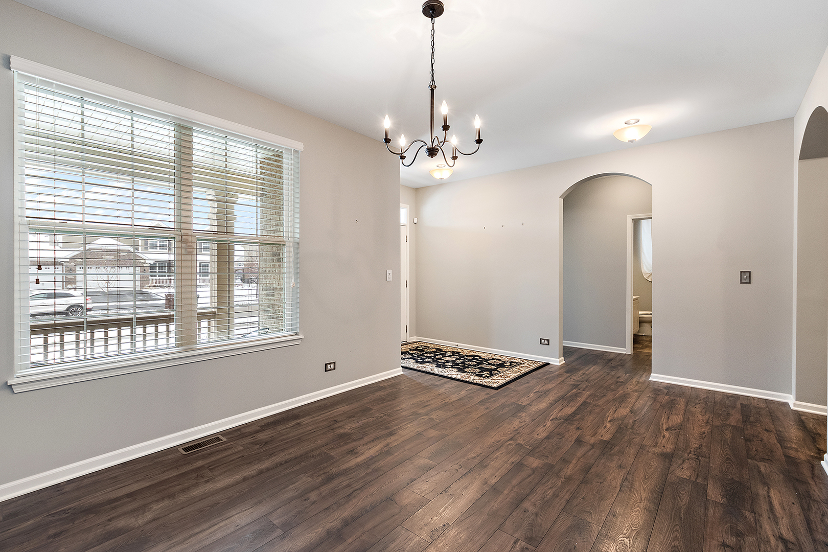 2073 Rownham Hill Road New Lenox, IL 60451 - Photo 4 of 34 a view of an empty room with window and wooden floor