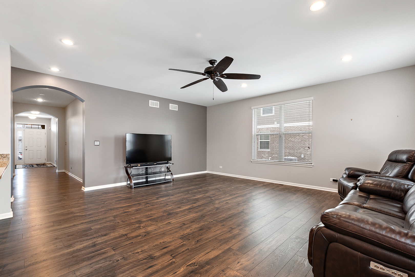 2073 Rownham Hill Road New Lenox, IL 60451 - Photo 6 of 34 a living room with furniture and a flat screen tv