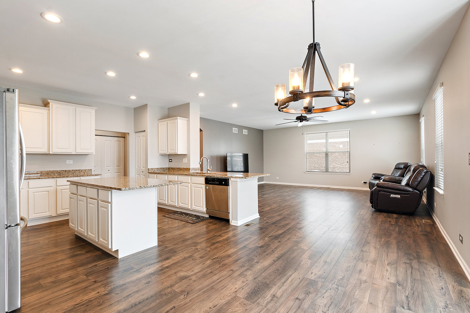2073 Rownham Hill Road New Lenox, IL 60451 - Photo 9 of 34 a kitchen with granite countertop a stove and wooden floor