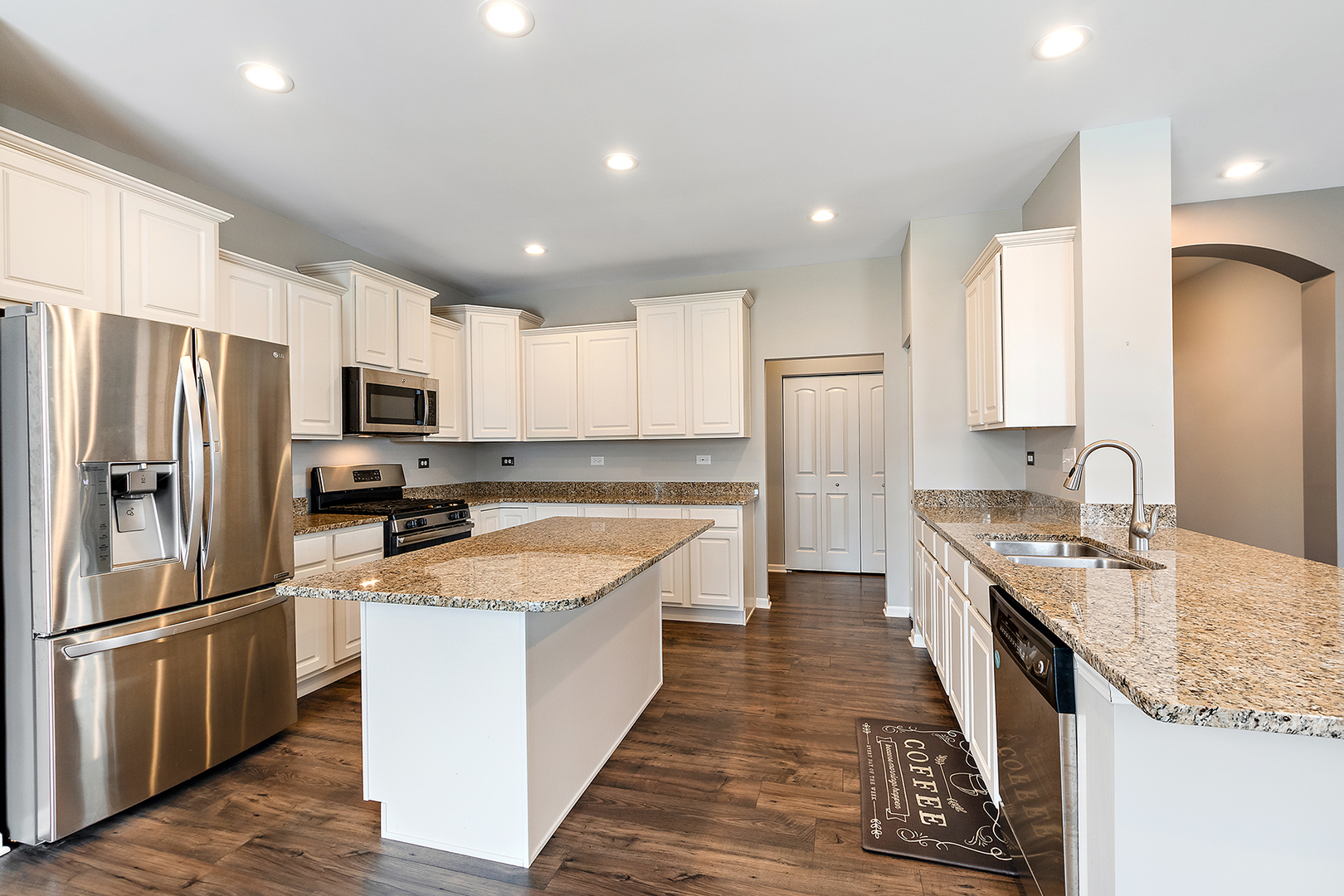 2073 Rownham Hill Road New Lenox, IL 60451 - Photo 10 of 34 a large kitchen with stainless steel appliances granite countertop a refrigerator a stove a sink and a microwave