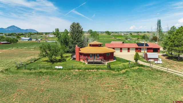 an aerial view of a house with pool lake view and mountain view