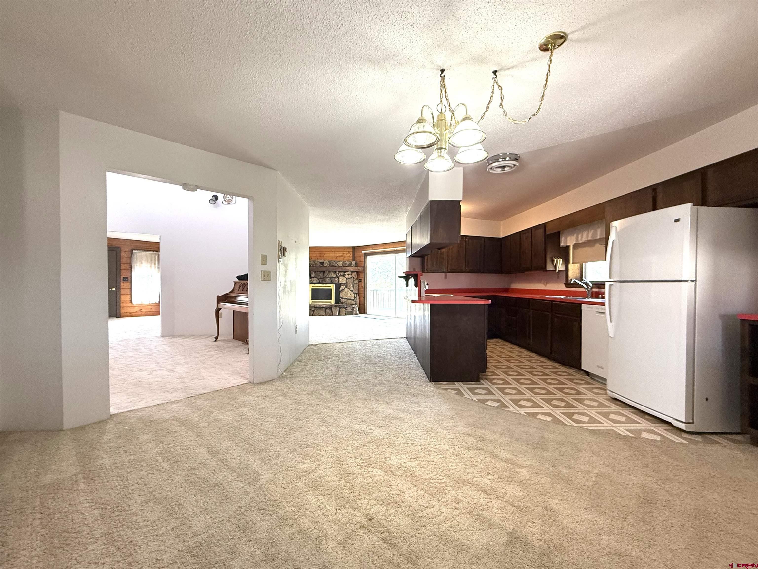 24816 Rd M.3 Cortez, CO 81321 - Photo 17 of 34 a view of a kitchen with a refrigerator and a chandelier