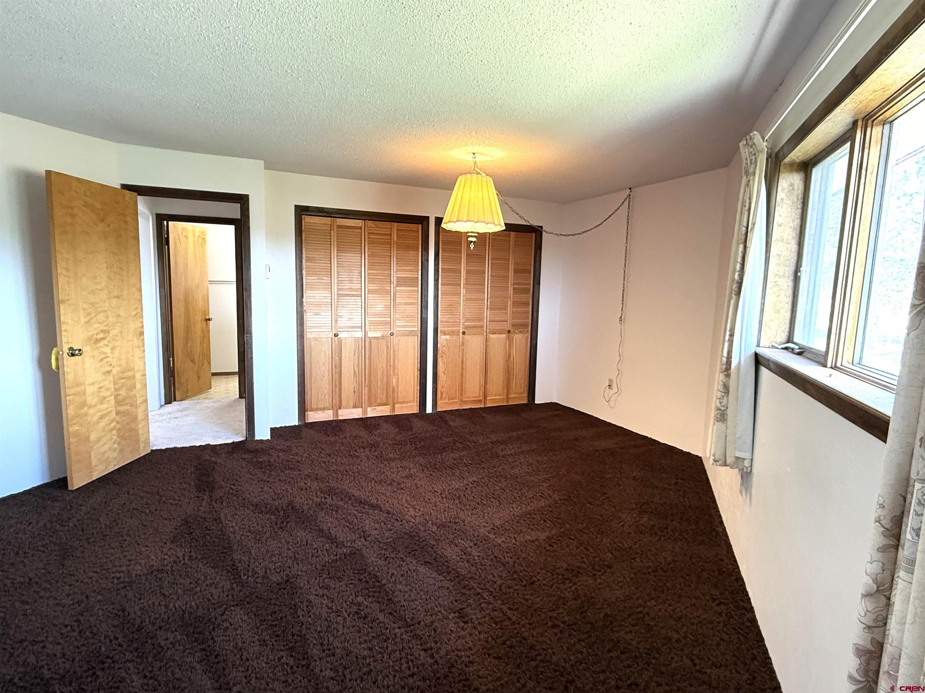 24816 Rd M.3 Cortez, CO 81321 - Photo 21 of 34 a bedroom with a bed and a large window