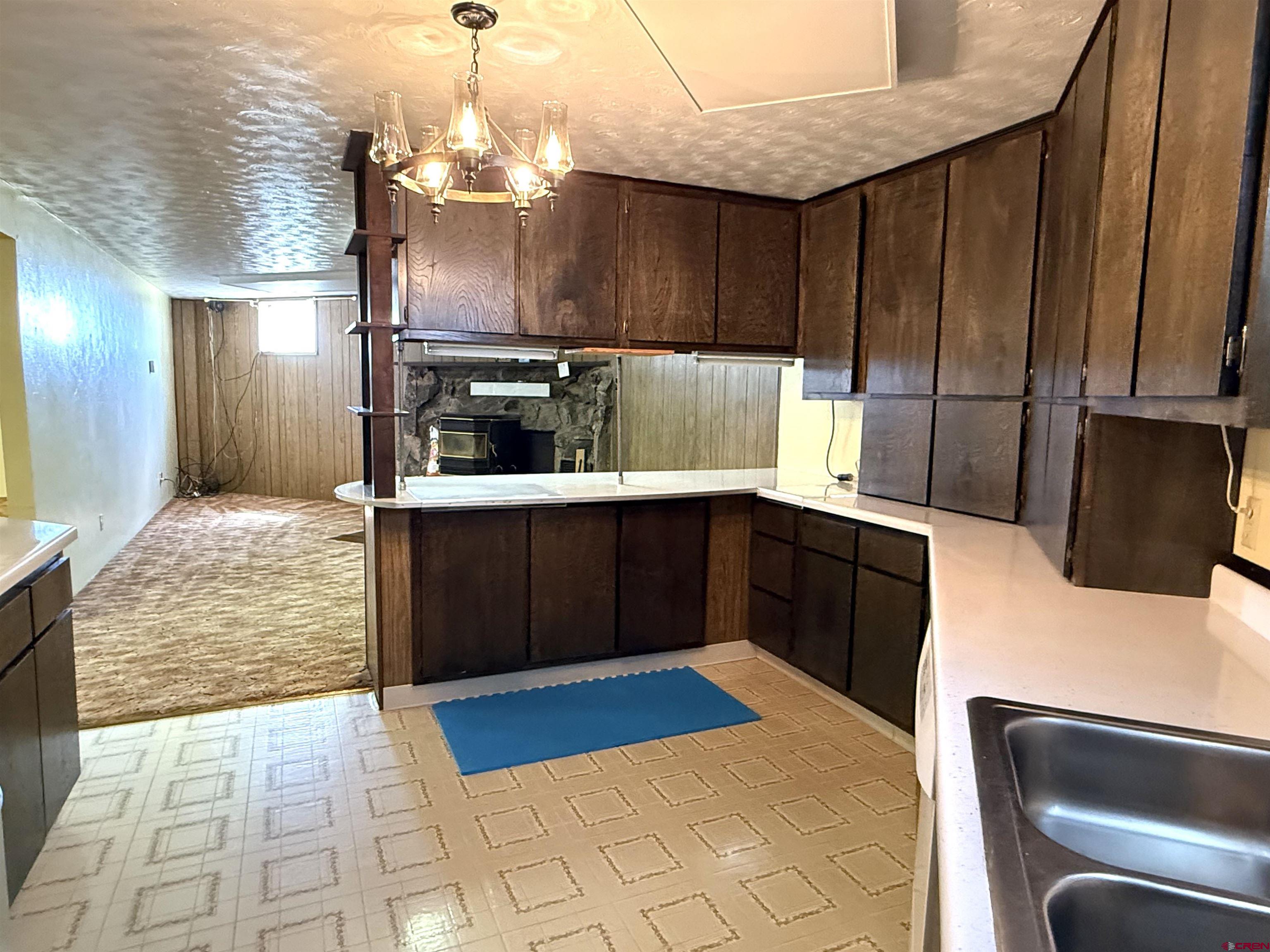 24816 Rd M.3 Cortez, CO 81321 - Photo 28 of 34 a kitchen with granite countertop a refrigerator stove and sink