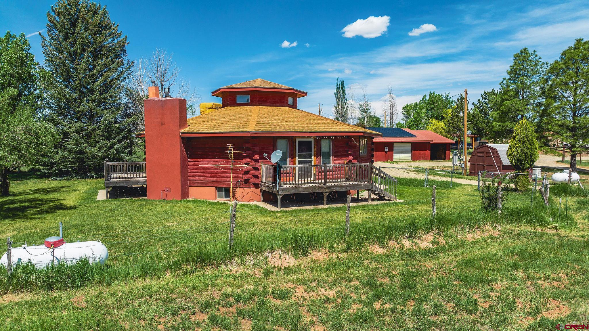 24816 Rd M.3 Cortez, CO 81321 - Photo 3 of 34 a front view of a house with a yard table and chairs