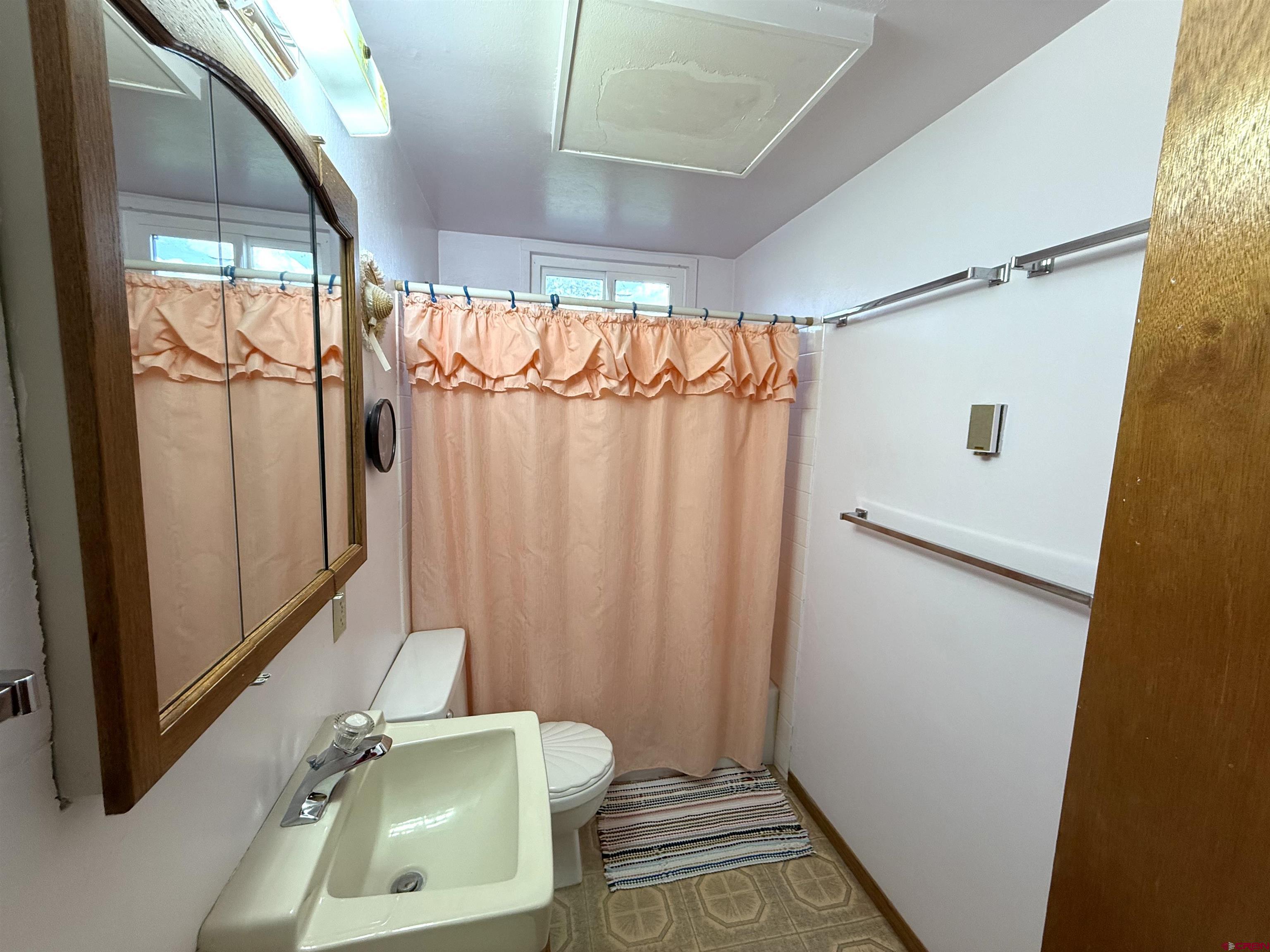 24816 Rd M.3 Cortez, CO 81321 - Photo 33 of 34 a bathroom with a sink a mirror and a shower