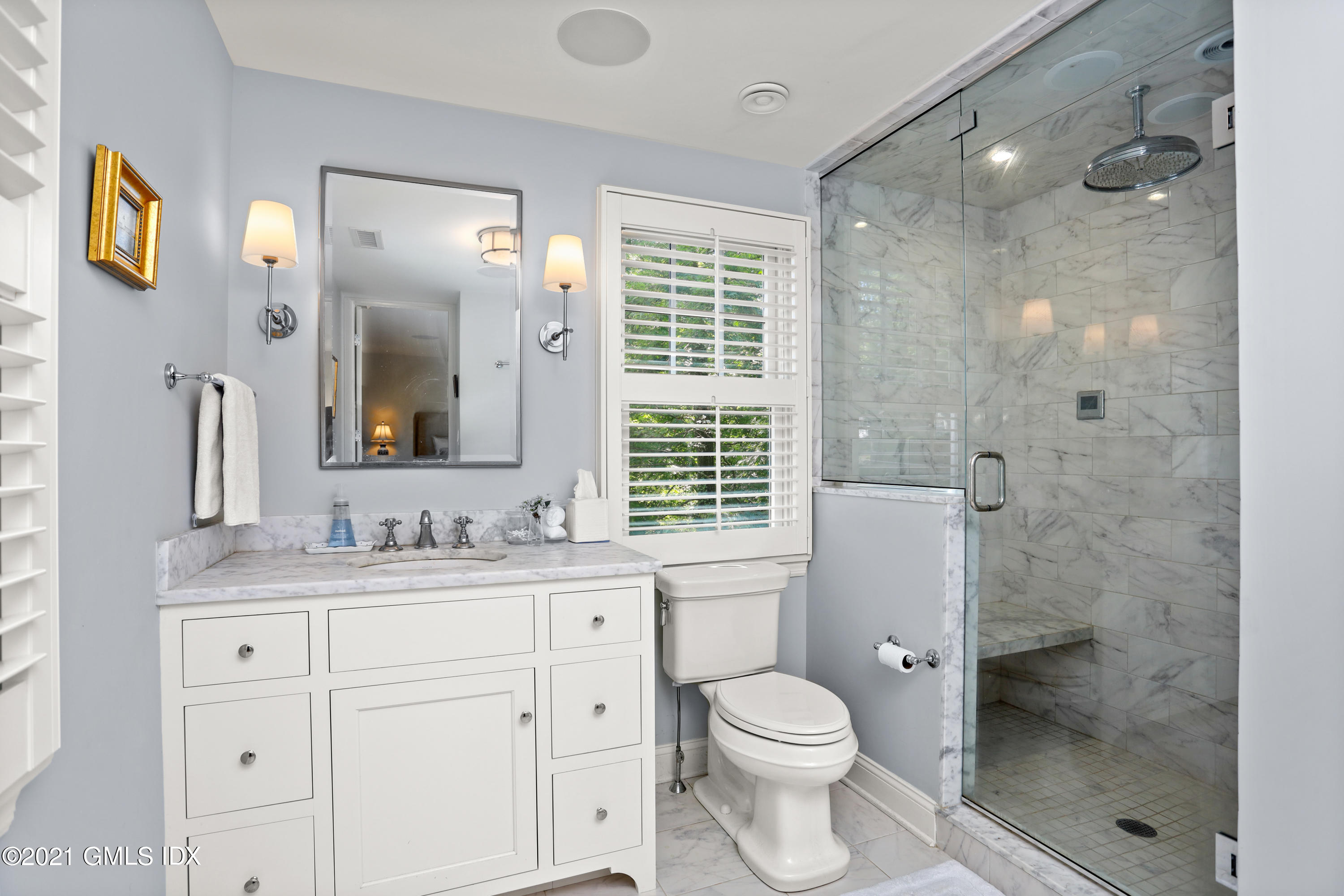 20 Ridge Road Cos Cob, CT 06807 - Photo 19 of 31 a bathroom with a double vanity sink toilet mirror and windows