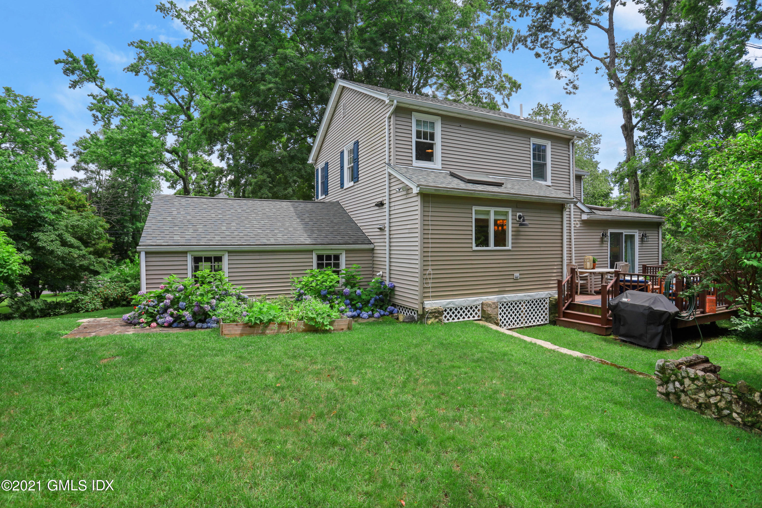 20 Ridge Road Cos Cob, CT 06807 - Photo 25 of 31 a front view of a house with a garden and trees