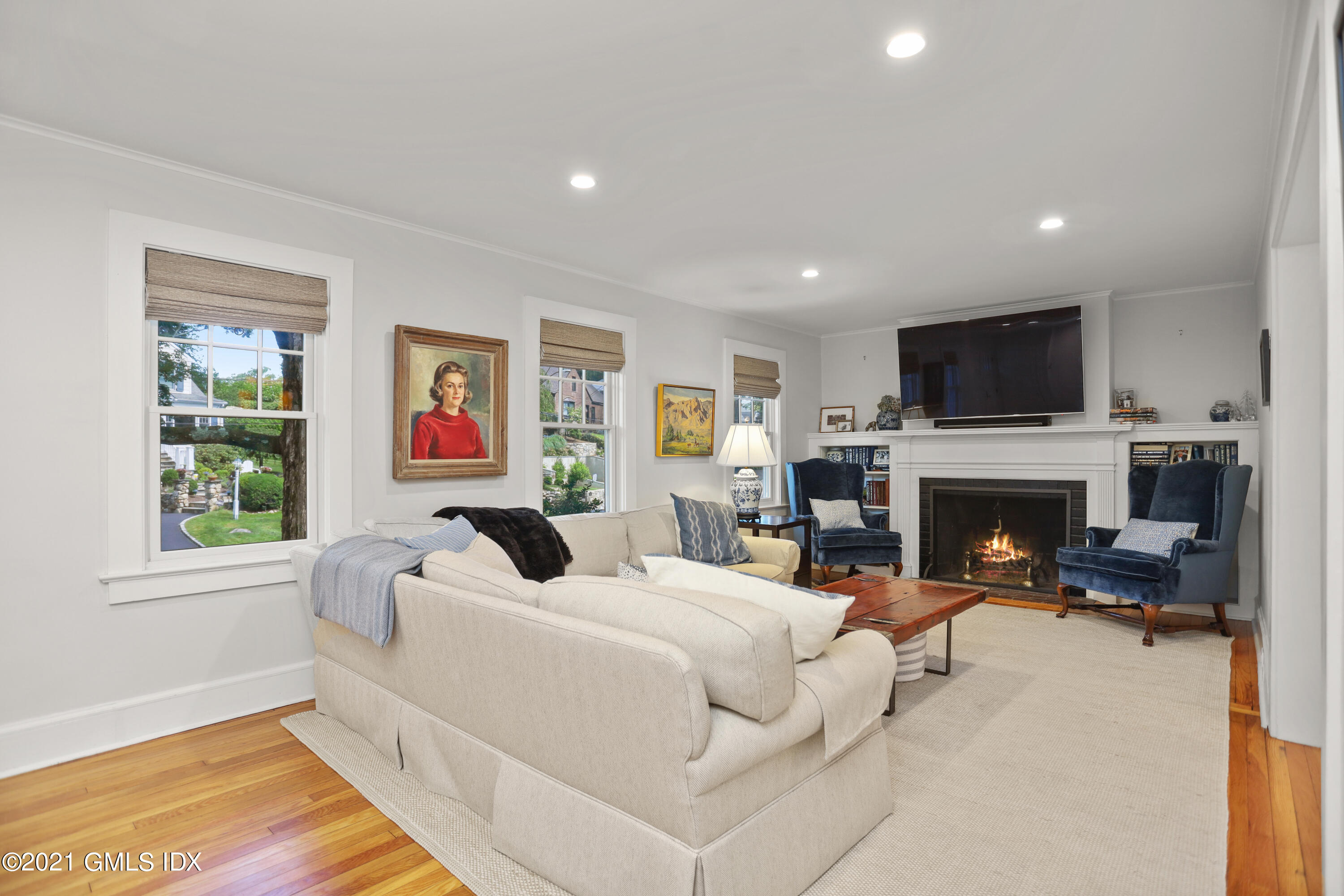 20 Ridge Road Cos Cob, CT 06807 - Photo 6 of 31 a living room with furniture a fireplace and a flat screen tv