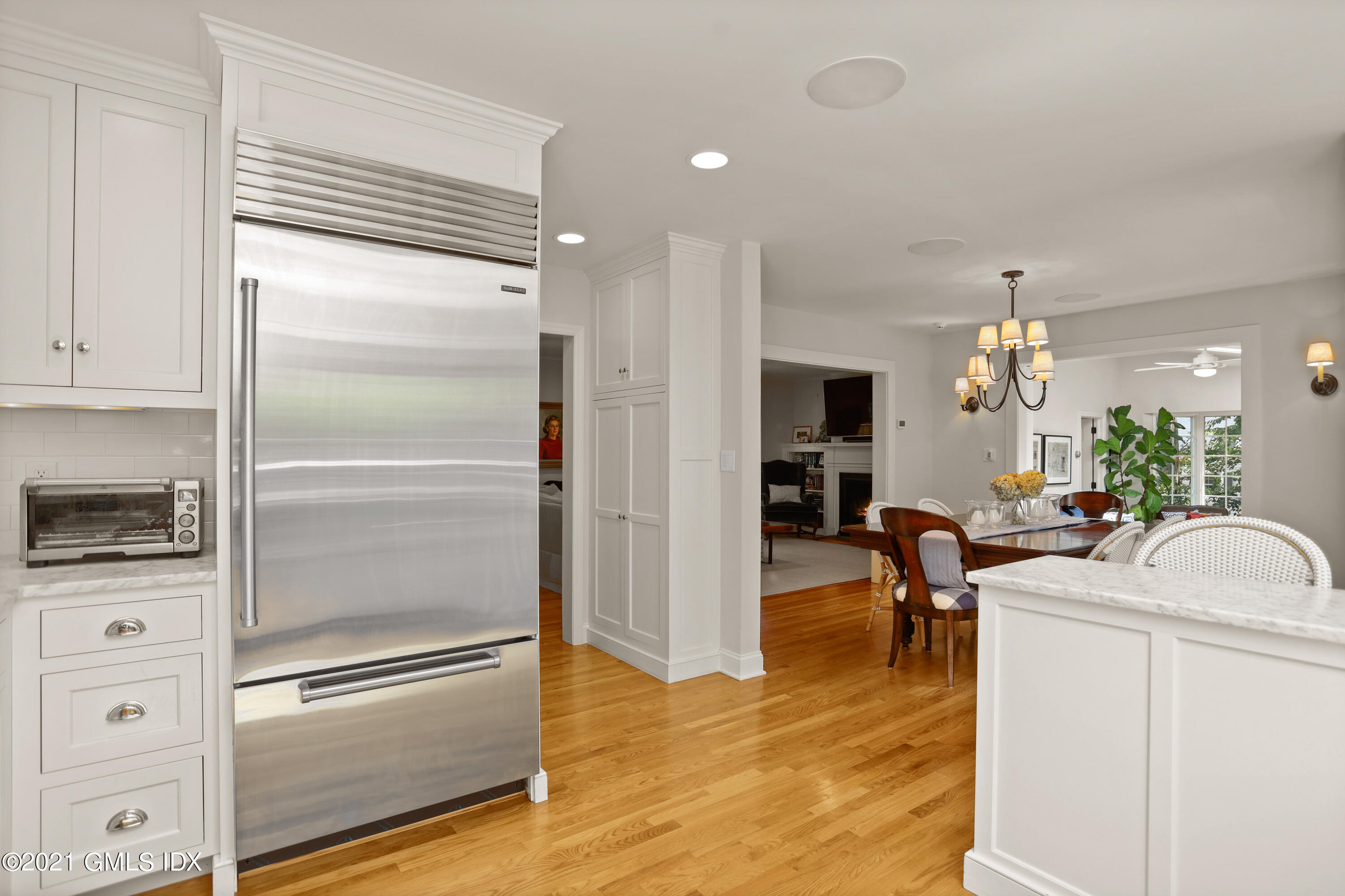 20 Ridge Road Cos Cob, CT 06807 - Photo 9 of 31 a view of a livingroom with furniture a fireplace a chandelier and wooden floor