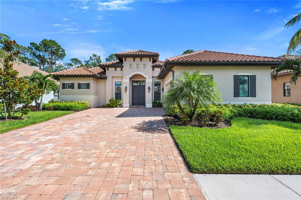 7437 Acorn Way Naples, FL 34119 - Photo 1 of 19 a front view of a house with a yard