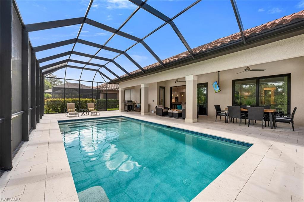 7437 Acorn Way Naples, FL 34119 - Photo 15 of 19 a view of swimming pool with seating area