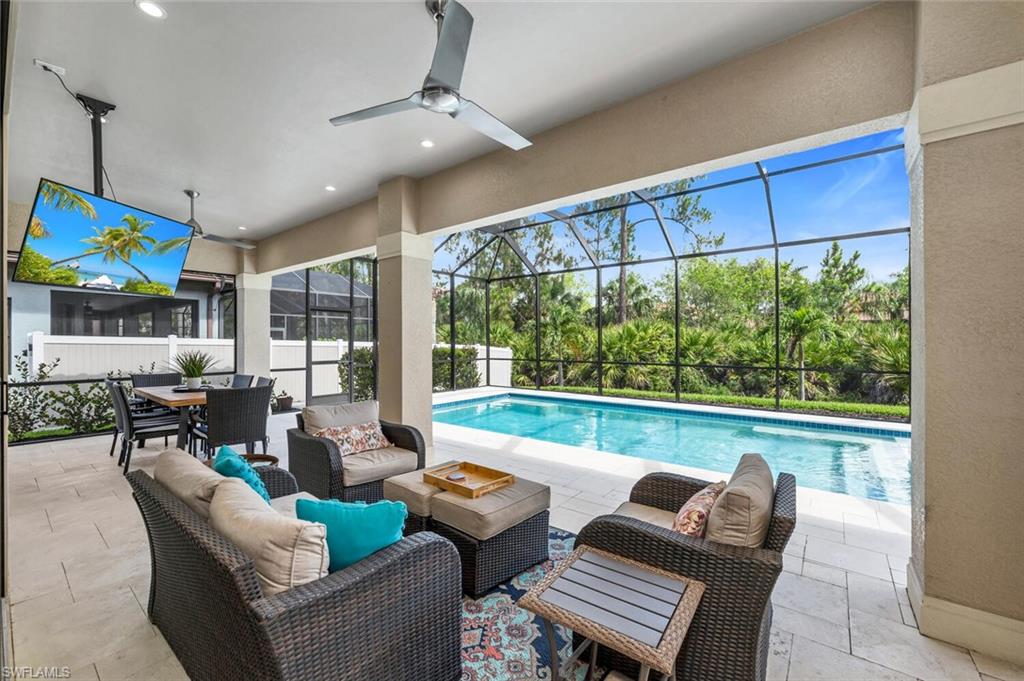 7437 Acorn Way Naples, FL 34119 - Photo 16 of 19 a living room with furniture a floor to ceiling window and floor to ceiling window
