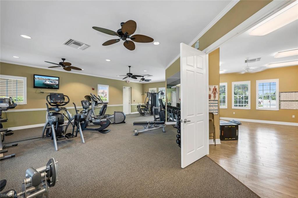 7437 Acorn Way Naples, FL 34119 - Photo 17 of 19 a view of a livingroom with furniture and a ceiling fan