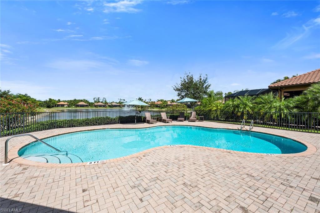 7437 Acorn Way Naples, FL 34119 - Photo 18 of 19 a view of swimming pool with a yard