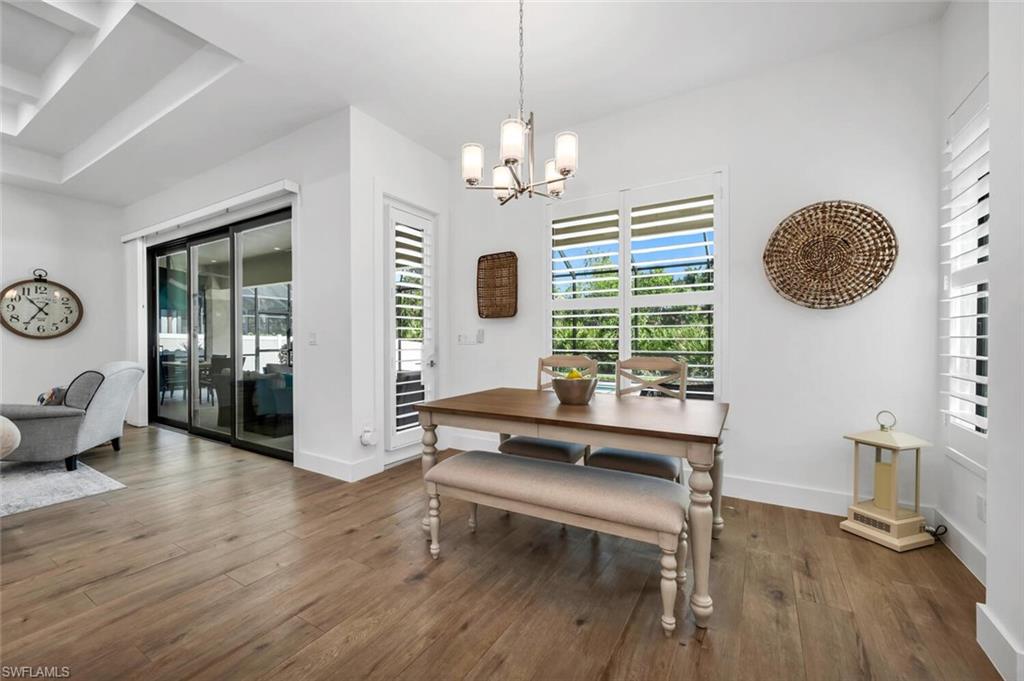 7437 Acorn Way Naples, FL 34119 - Photo 4 of 19 a view of a room with furniture window and wooden floor