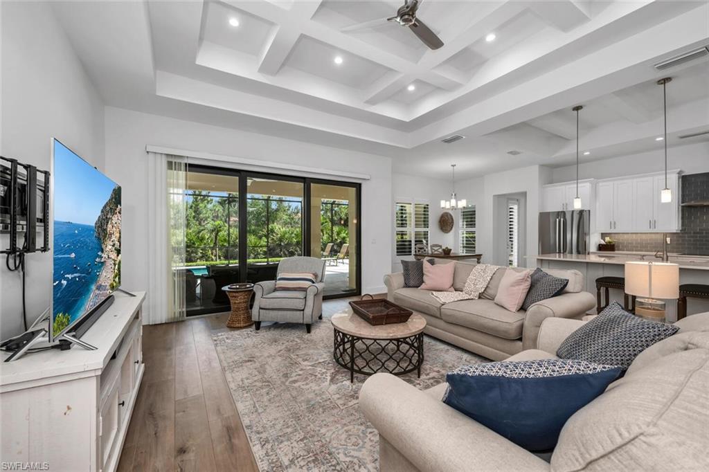 7437 Acorn Way Naples, FL 34119 - Photo 5 of 19 a living room with furniture and a flat screen tv
