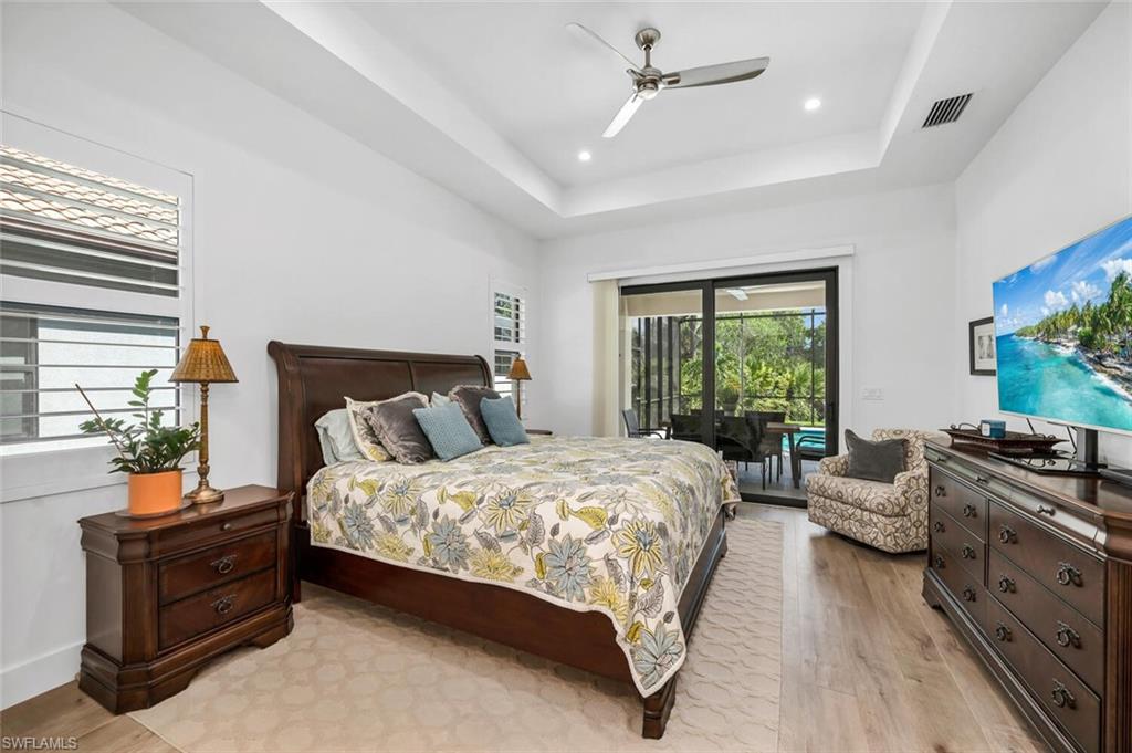 7437 Acorn Way Naples, FL 34119 - Photo 7 of 19 a bedroom with a bed and a couch