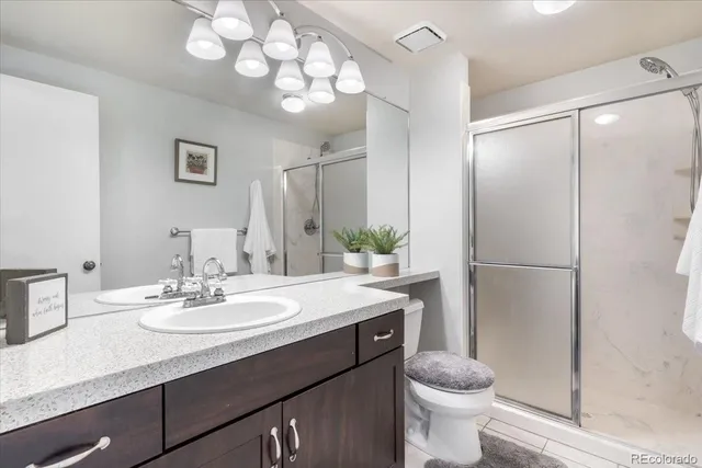 a bathroom with a sink toilet and a mirror