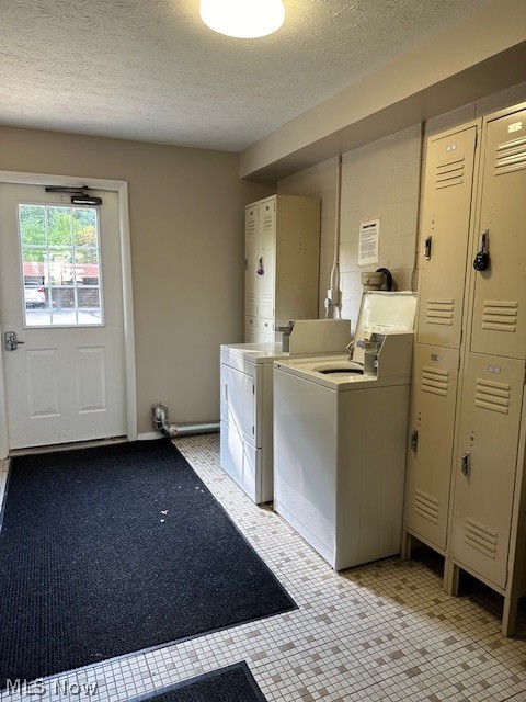 4376 Darrow Road, Unit 7 Stow, OH 44224 - Photo 22 of 23 Clothes washing area with a textured ceiling, light tile patterned floors, and washing machine and dryer