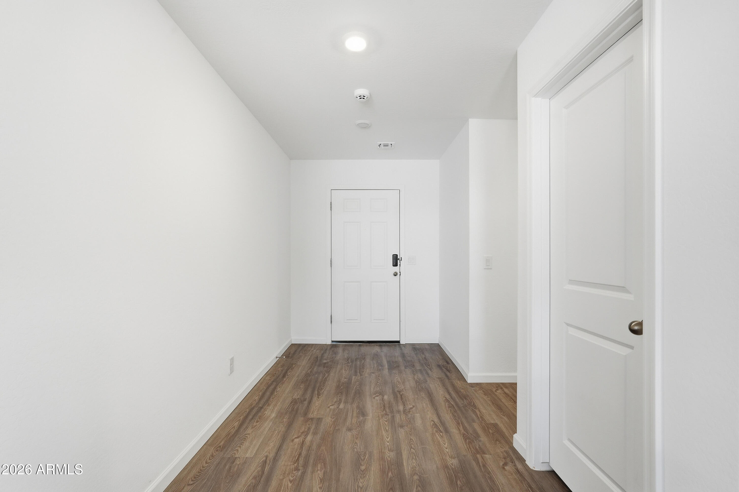 15610 South Moon Valley Road Arizona City, AZ 85123 - Photo 5 of 36 a view of a room with wooden floor and white doors