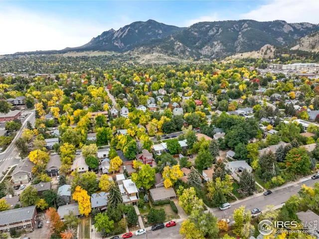 a view of a lush green field with mountains in the background