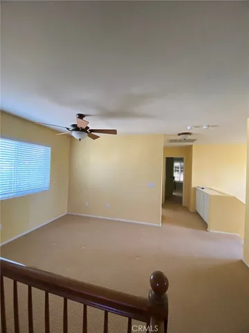 a view of a room with a ceiling fan