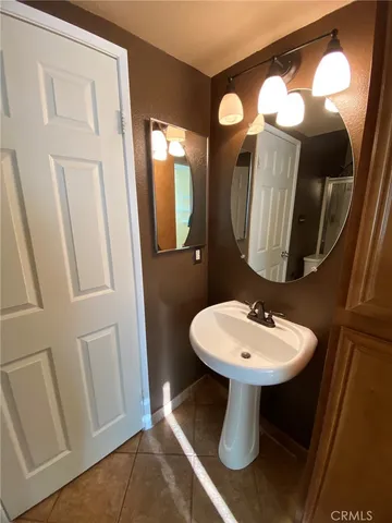 a bathroom with a sink a mirror and a mirror
