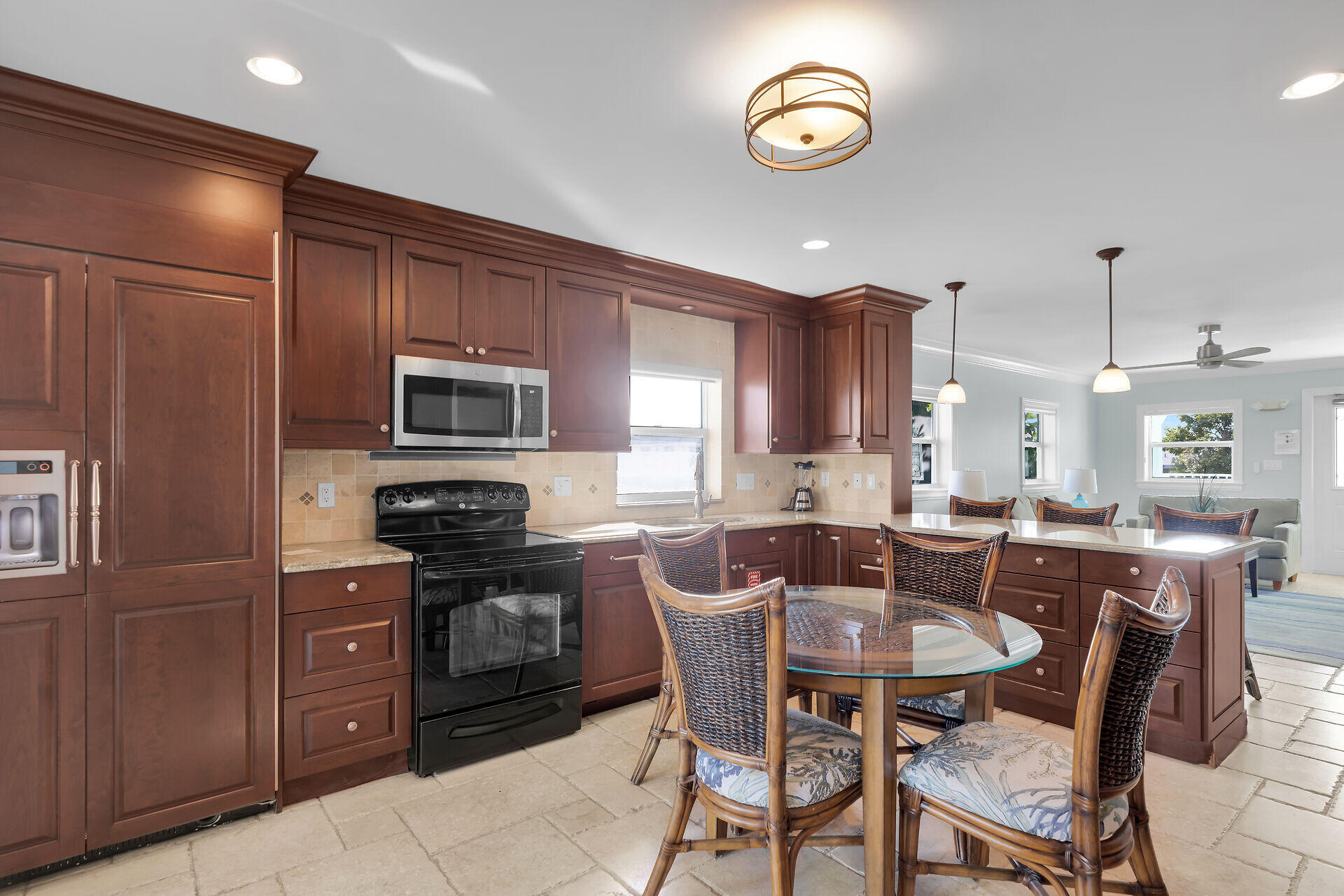 580-590 10th Street Key Colony Beach, FL 33051 - Photo 52 of 75 a kitchen with microwave a refrigerator and chairs