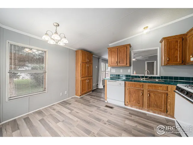 a view interior of the kitchen granite countertop cabinets and window