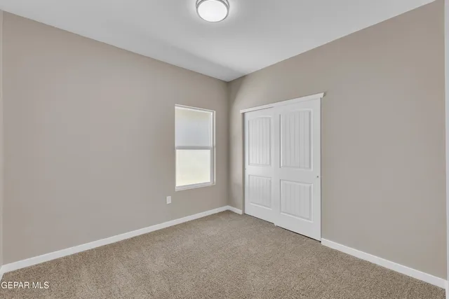 a kitchen with stainless steel appliances granite countertop a sink a stove a refrigerator and white cabinets with wooden floor