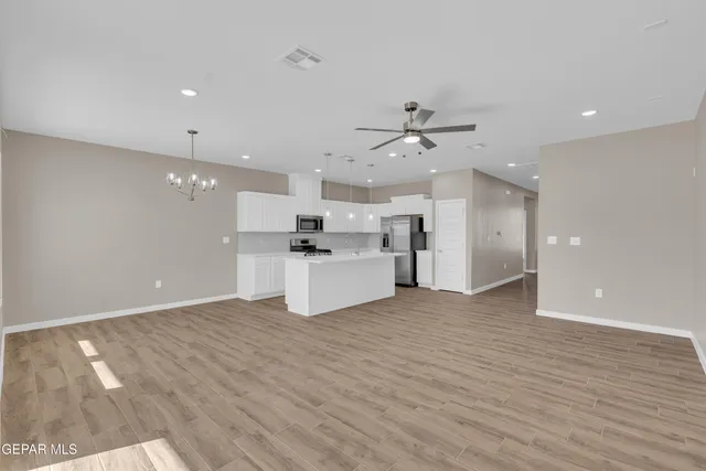 a view of a kitchen with furniture and wooden floor
