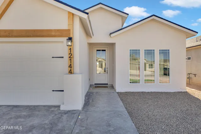 a view of a hallway with wooden floor and a living room