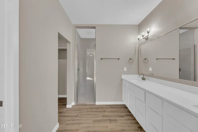 a bathroom with double vanity sink and a mirror