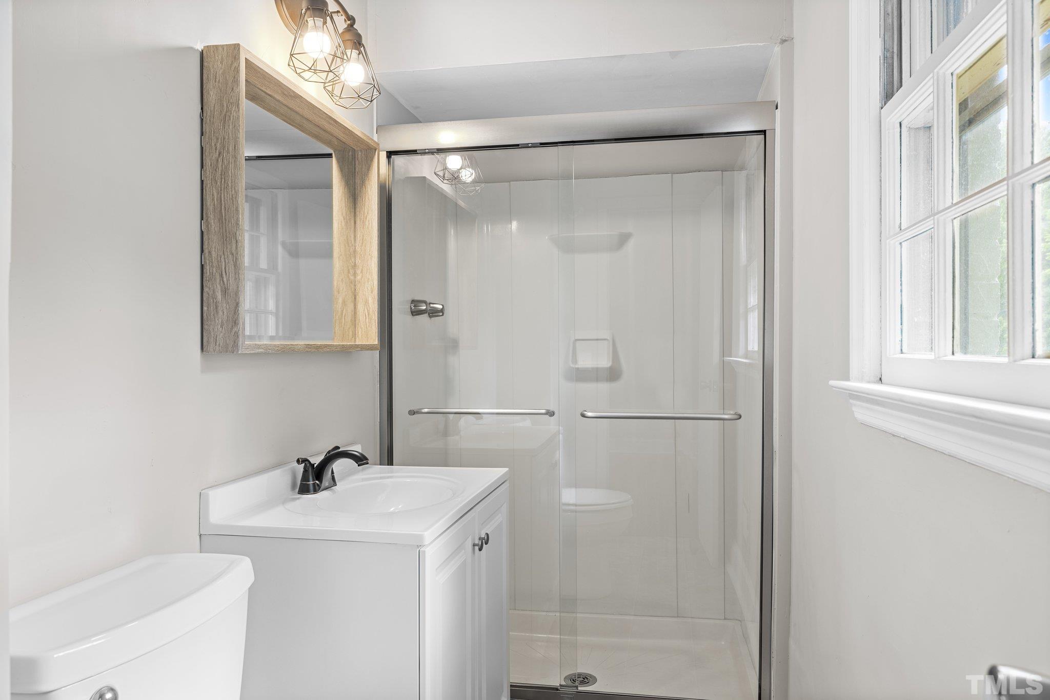 270 Burlington Road Roxboro, NC 27573 - Photo 25 of 37 a bathroom with a sink a toilet and shower