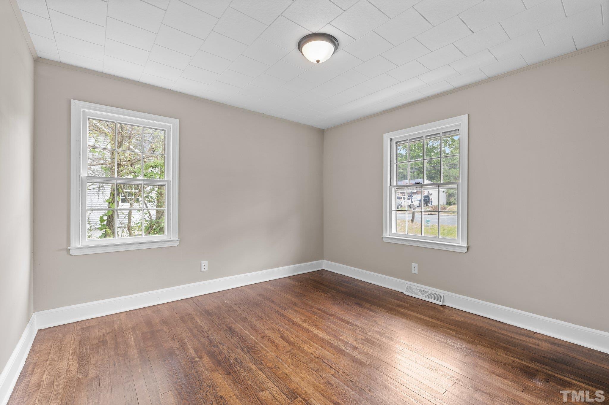 270 Burlington Road Roxboro, NC 27573 - Photo 27 of 37 a view of an empty room with wooden floor and a window