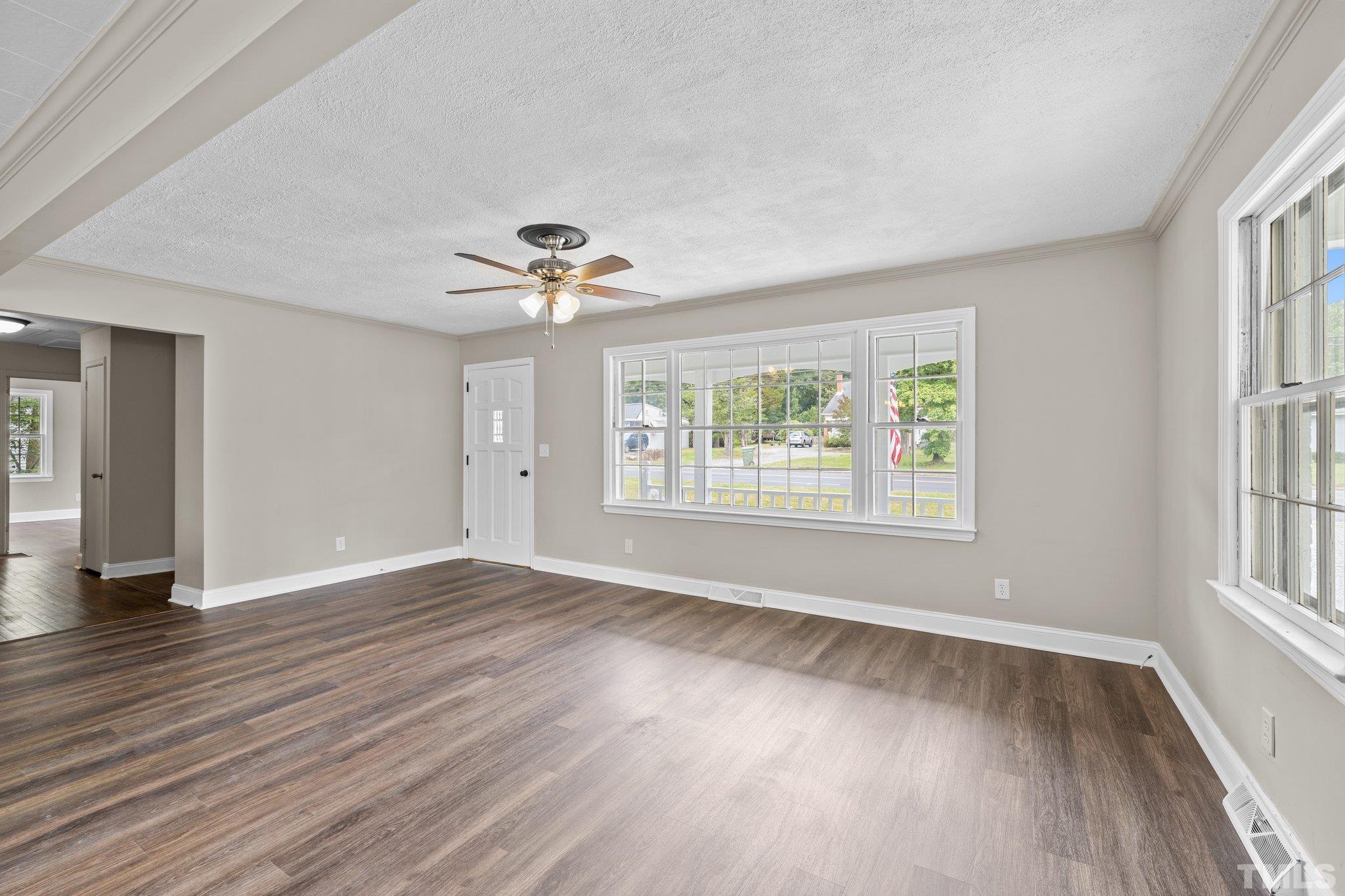 270 Burlington Road Roxboro, NC 27573 - Photo 8 of 37 a view of an empty room with wooden floor and a window