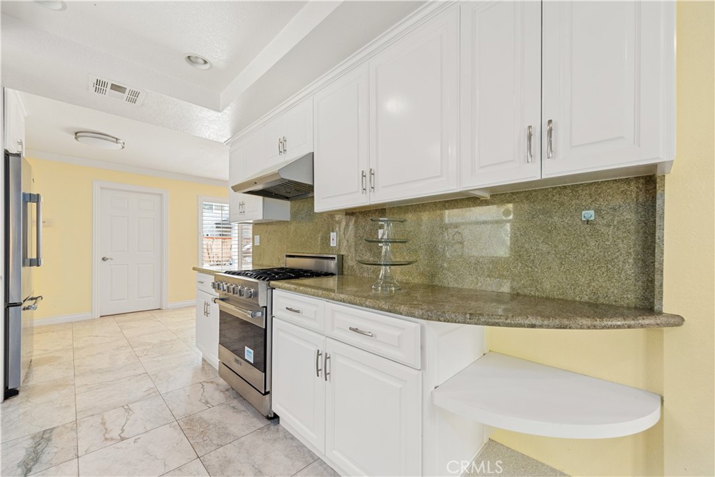 21236 Greenbrook Drive Walnut, CA 91789 - Photo 24 of 49 a kitchen with stainless steel appliances granite countertop a stove a sink and a refrigerator