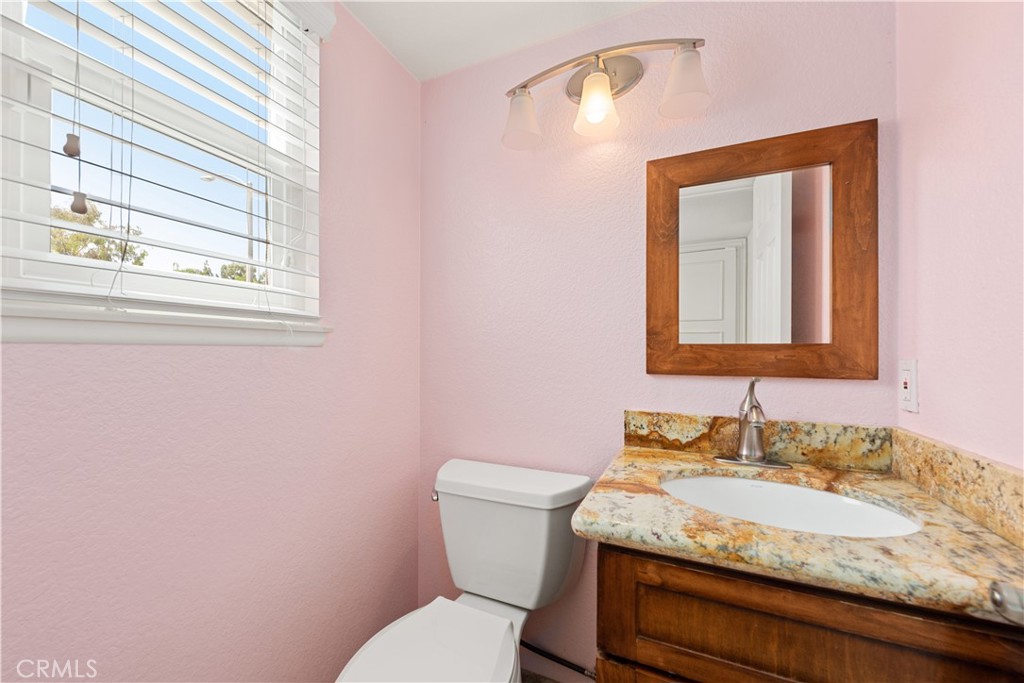 21236 Greenbrook Drive Walnut, CA 91789 - Photo 27 of 49 a bathroom with a granite countertop toilet sink and mirror