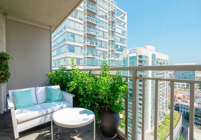 a city view from a balcony with outdoor seating