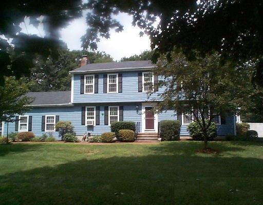 a front view of a house with a garden and plants