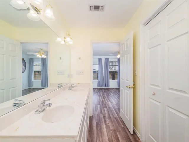 a spacious bathroom with a sink mirror and shower