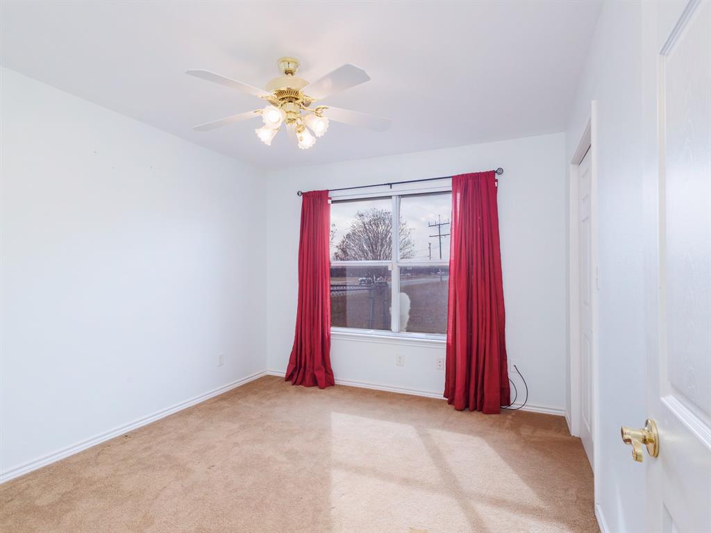 202 Abby Road Early, TX 76802 - Photo 18 of 28 a view of a room with a chandelier fan and windows
