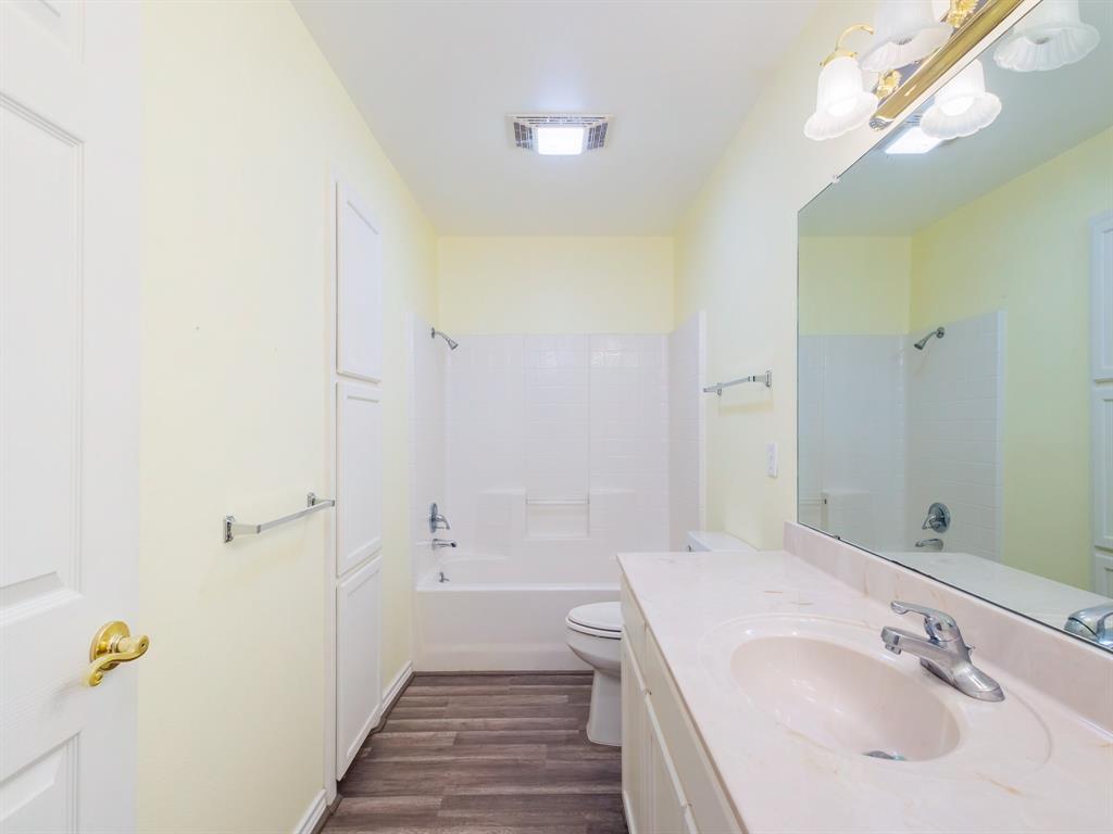 202 Abby Road Early, TX 76802 - Photo 20 of 28 a bathroom with a sink a toilet a shower and a mirror